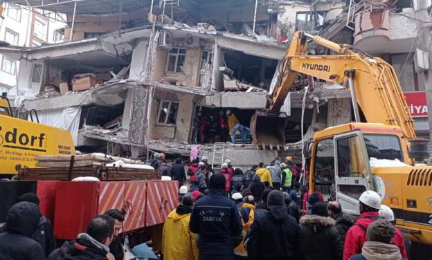 Emergency personnel search for victims at site of collapsed building in Diyarbakir, Turkey